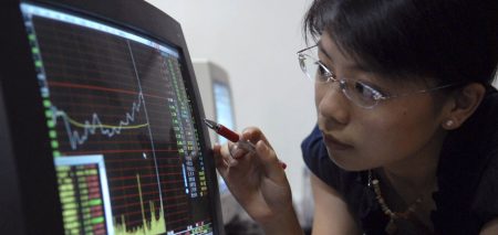 Juanjuan, a college student, checks stock information at a stock exchange in Fuzhou, southeast China's Fujian province, September 10, 2007. Fujian province has told schools to caution students against dabbling in the stock market, warning that failed investments could fuel social instability. REUTERS/Stringer (CHINA) CHINA OUT - RTR1TOAI